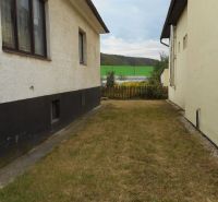 A family house in Trenčín with a narrow garden between two buildings.