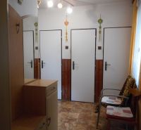 Interior of a family house with a wooden decor floor and simple furniture.