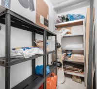Storage space with shelves and various items in a 2-room apartment.