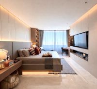 A bedroom in a 3-room apartment with soft lighting and a wooden decor floor.