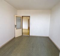 An empty room in a 3-room apartment with open doors and a green floor.