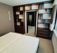 Bedroom in a 3-room apartment with shelves and a large window.