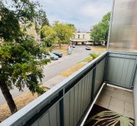 The balcony of a 3-room apartment on Malá okružná in Partizánske with a view of the street and trees.