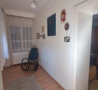 Interior of a family house with a wooden decor floor and a rocking chair.