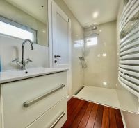 Bathroom with a shower and a wooden decor floor in the Garden area.