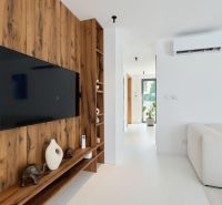 Living room with wood-patterned flooring and a TV in a 4-room apartment.