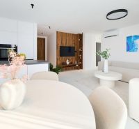 Kitchen and living room of a 4-room apartment with wood-patterned flooring, white interior, and decorations.