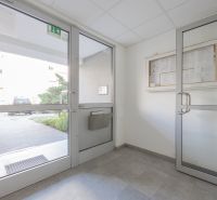 Entrance hall with glass doors and information on the wall, Kapicova Street, Bratislava - Dvory.