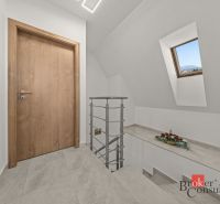 Interior of a 4-room apartment with wooden doors, tiles, and a skylight.
