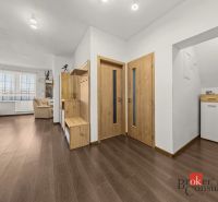 The entrance hall of a 4-room apartment with a wooden decor floor and wooden furniture.