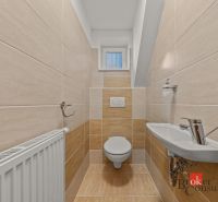 A bathroom in a 4-room apartment with a sink and a small window.