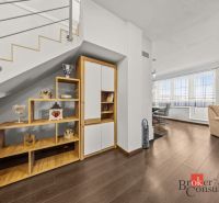 Interior of a 4-room apartment with a wooden decor floor, stairs, and an open living area.