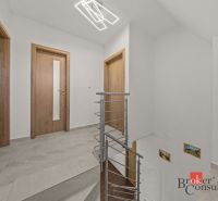 A staircase with wooden doors and railing in the interior of a 4-room apartment.