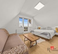 Bright bedroom in a 4-room apartment with wood-decor flooring and a balcony.