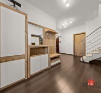 A hallway in a 4-room apartment with a wooden decor floor and a staircase.