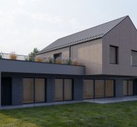 A family house in Staškov with wooden cladding and large windows.
