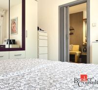 A bedroom in a 3-room apartment with a mirrored wardrobe and interior decorations.