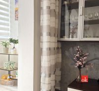 Interior of a 3-room apartment with flowers, a shelf, and decorations on the shelf by the window.