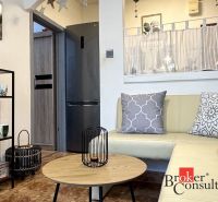 Living room with comfortable seating and decorative pillows in a 3-room apartment.