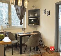 Dining area with a table and chairs, next to the entrance to the bedroom in a 3-room apartment.