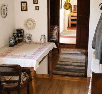 Traditional cottage interior with rustic decor, wooden patterned flooring.
