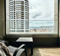 A view from the balcony of a two-room apartment of the panorama of Bratislava and a modern skyscraper.