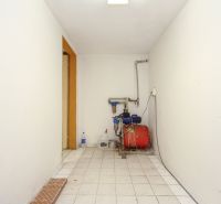 A technical room with white walls and equipment installation in a family house.