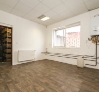A white interior of a family house with a boiler and a wooden decor floor.