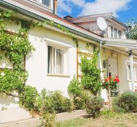 A family house in Rožňava with climbing plants and a two-story roof.