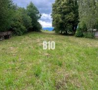 A grassy plot surrounded by trees in Dubové, ideal for cottage purposes.
