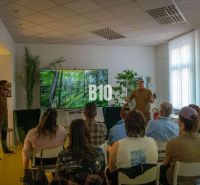 A group of people in an office with a nature projection on the screen.