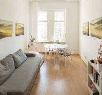 Cozy offices with a sofa, desk, and wood-decorated flooring.
