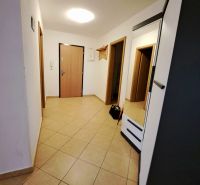 An entrance hall with tiles and a coat rack in a 2-room apartment.