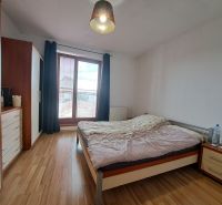 Bedroom in a 2-room apartment with a bed and a floor with a wooden decor.