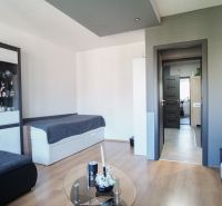 Living room in a 3-room apartment with a wooden decor floor and modern decoration.