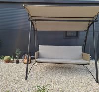 Recreational apartment in Sukošan: garden swing surrounded by plants on a gravel surface.