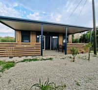 Recreational apartment in Sukošan with a terrace, garden seating, and gravel paving.