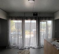 Recreational apartment with blackout curtains and garden view.