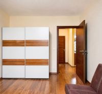 3-room apartment with wood-patterned flooring, a wardrobe, and open doors.