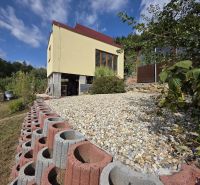 A cottage on Tulská Street in Banská Bystrica with an elevated garden and stone landscaping.
