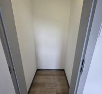 Small room in a cabin with a wooden decor floor and white walls.