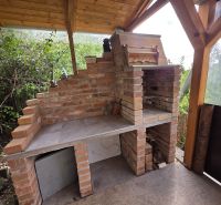 Baking in a cottage with a brick oven and a wooden roof in the garden.