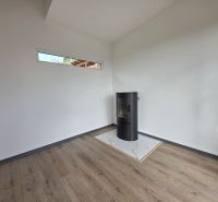 The interior of a cabin with a fireplace and a wooden decor floor.