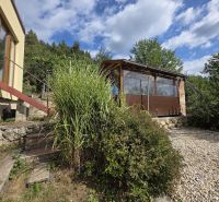 The house on Tulská Street in Banská Bystrica, surrounded by greenery and a stone path.