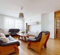 Living room in a 3-room apartment with a leather sofa set and a floor with a wooden decor.