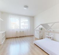 Children's room in a 3-room apartment with a wooden decor floor and white walls.