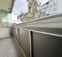 A balcony with tiles, railing, and a view of a building in Krásno nad Kysucou, Struhy, 3-room apartment.