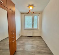 A room with a wooden decor floor and a built-in wardrobe in a 3-room apartment.