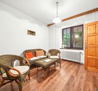 Cozy interior of a family house with wicker furniture and a wooden decor floor.