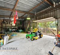 A family house in Lipov with a garage full of tools and a lawnmower.